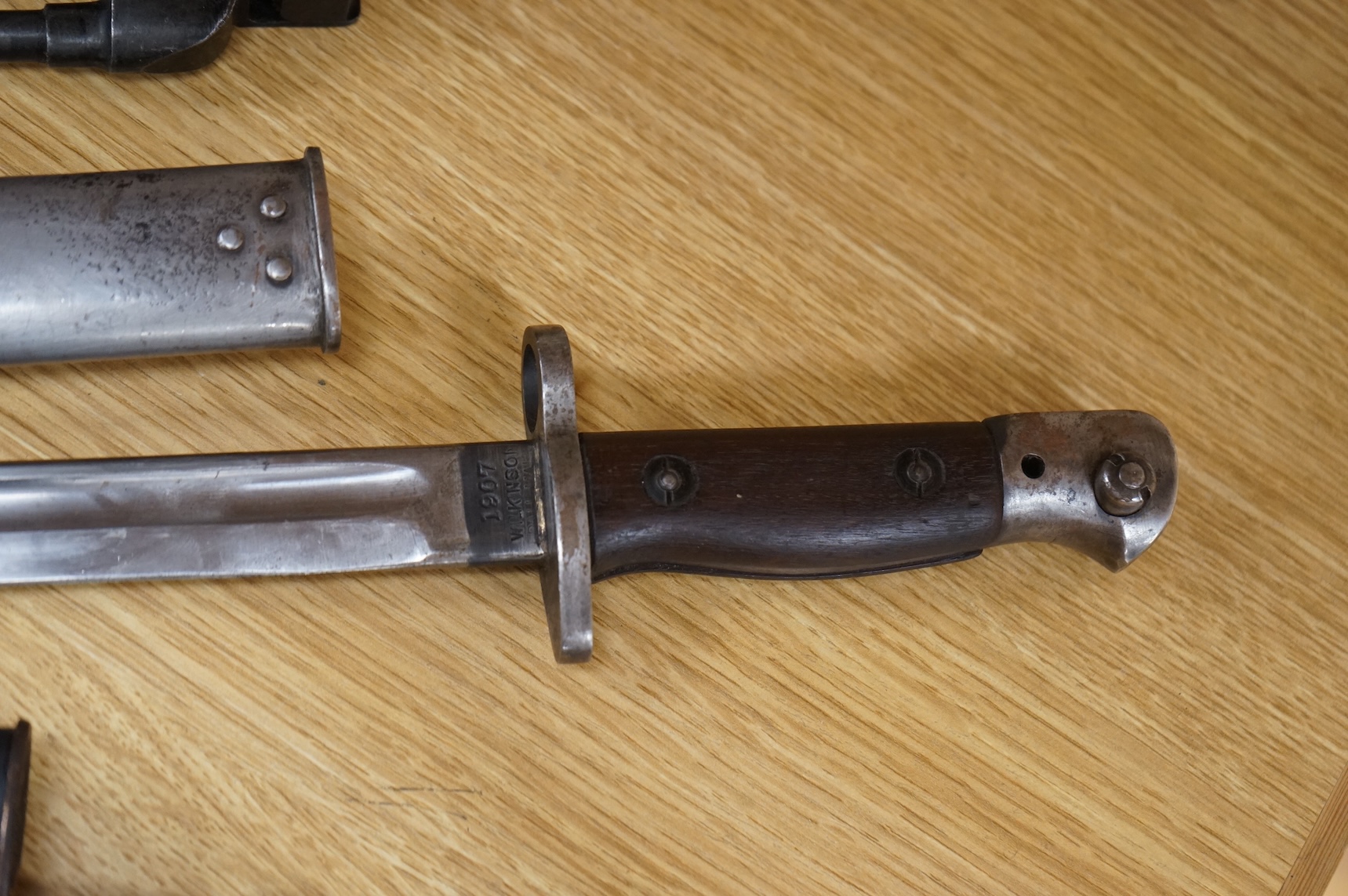 A 1907 bayonet by Wilkinson in its steel mounted leather scabbard, another similar with leather frog, two small British bayonets, a Continental bayonet, and two assorted hunting knives (7)
